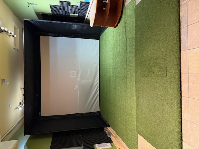 An ultra-modern indoor golf simulator room